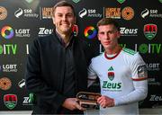 24 May 2024;  Evan McLaughlin of Cork City is presented with the player of the match award by SSE Airtricty digital marketing lead Gar Murphy during the SSE Airtricity LGBT Ireland Football Takeover at Turner's Cross in Cork after the SSE Airtricty Men's First Division match between Cork City FC and Treaty United FC at Turner's Cross in Cork. Photo by Tyler Miller/Sportsfile