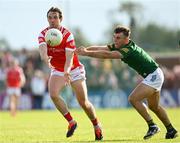 25 May 2024; Bevan Duffy of Louth in action against Seán Coffey of Meath during the GAA Football All-Ireland Senior Championship Round 1 match between Louth and Meath at Grattan Park in Inniskeen, Monaghan. Photo by Daire Brennan/Sportsfile