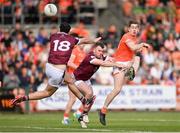 25 May 2024; Andrew Murnin of Armagh kicks a point despite Charlie Drumm, left, and Jamie Gonoud of Westmeath during the GAA Football All-Ireland Senior Championship Round 1 match between Armagh and Westmeath at the Box It Athletic Grounds in Armagh. Photo by Ben McShane/Sportsfile