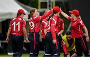 26 May 2024;Dragons players celebrate after taking the wicket of Laura Delaney of Typhoons during the Evoke Super 50 Cup match between Dragons and Typhoons at CIYMS Cricket Club, Belmont in Belfast. Photo by Oliver McVeigh/Sportsfile