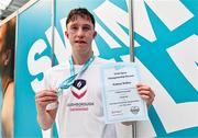 26 May 2024; Nathan Wiffen of Larne SC poses for a portrait with his winners medal and Irish open championship record certificate after competing in the men's 1500m freestyle final during day five of the Ireland Olympic Swimming Trials at the National Aquatic Centre on the Sport Ireland Campus in Dublin. Photo by Tyler Miller/Sportsfile