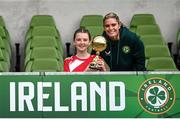 29 May 2024; Roise Walsh of Gurrane NS, Cork, is presented with the Player of the Tournament award for girls section A cup, for small sized schools, by Republic of Ireland's Jamie Finn during the FAI Primary 5s Finals day at Aviva Stadium in Dublin. Photo by Stephen McCarthy/Sportsfile