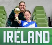 29 May 2024; Hattie Farrell of Our Lady’s Grove PS, Dublin, is presented with the girls section C cup, for large sized schools, Player of the Tournament award by Republic of Ireland's Jamie Finn during the FAI Primary 5s Finals day at Aviva Stadium in Dublin. Photo by Stephen McCarthy/Sportsfile