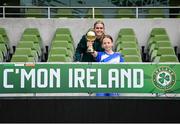 29 May 2024; Hattie Farrell of Our Lady’s Grove PS, Dublin, is presented with the girls section C cup, for large sized schools, Player of the Tournament award by Republic of Ireland's Jamie Finn during the FAI Primary 5s Finals day at Aviva Stadium in Dublin. Photo by Stephen McCarthy/Sportsfile
