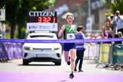 2 June 2024; Íde Nic Dhómhnaill of West Limerick AC crosses the finish line to finish first in the 2024 Vhi Women’s Mini Marathon. More than 25,000 women from all over the country took to the streets of Dublin to run, walk and jog the 10km route, raising much needed funds for hundreds of charities around the country. For further information please log on to www.vhiwomensminimarathon.ie. Photo by Ramsey Cardy/Sportsfile