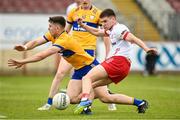 2 June 2024; Niall Devlin of Tyrone scoring his sides first goal despite the attention of Brian McNamara of Clare  during the GAA Football All-Ireland Senior Championship Round 2 match between Tyrone and Clare at O'Neill's Healy Park in Omagh, Tyrone.