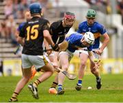 2 June 2024; Conor Grace of Tipperary Blue in action against James Reid of Kilkenny during the Electric Ireland Corn Michael Hogan Celtic Challenge final match between Tipperary Blue and Kilkenny at UPMC Nowlan Park in Kilkenny. Photo by Tom Beary/Sportsfile