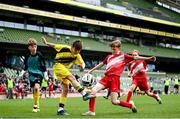 29 May 2024; Oisin Cuskelly of Illistrin NS, Donegal, yellow, and Kieran Stack of Beaumont BNS, Blackrock, Cork, during the FAI Primary 5s Finals day at Aviva Stadium in Dublin. Photo by Stephen McCarthy/Sportsfile