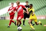 29 May 2024; Sam Bruton of Beaumont BNS, Blackrock, Cork, and Amini Twalib of Illistrin NS, Donegal, right, during the FAI Primary 5s Finals day at Aviva Stadium in Dublin. Photo by Stephen McCarthy/Sportsfile