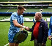 7 June 2024; Leinster co-captain Garry Ringrose shakes hands with Colin Bell of the Kevin Bell Repatriation Trust during the BKT United Rugby Championship Irish Shield presentation after a Leinster Rugby captain's run at the Aviva Stadium in Dublin. Photo by Harry Murphy/Sportsfile