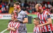 7 June 2024; Brian Maher, left, and Mark Connolly of Derry City with their mascots, as part of the club's 'Different Together' project, before the SSE Airtricity Men's Premier Division match between Derry City and Galway United at The Ryan McBride Brandywell Stadium in Derry. Photo by Ramsey Cardy/Sportsfile