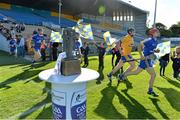 14 September 2013; The Clare team run out past the trophy before the game. Bord Gáis Energy GAA Hurling Under 21 All-Ireland 'A' Championship Final, Antrim v Clare, Semple Stadium, Thurles, Co. Tipperary. Picture credit: Brendan Moran / SPORTSFILE