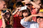 14 September 2013; Supporters use the match programme to shield their eyes from the sun. Bord Gáis Energy GAA Hurling Under 21 All-Ireland 'A' Championship Final, Antrim v Clare, Semple Stadium, Thurles, Co. Tipperary. Picture credit: Ray McManus / SPORTSFILE