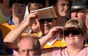14 September 2013; Supporters use the match programme to shield their eyes from the sun. Bord Gáis Energy GAA Hurling Under 21 All-Ireland 'A' Championship Final, Antrim v Clare, Semple Stadium, Thurles, Co. Tipperary. Picture credit: Ray McManus / SPORTSFILE