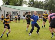 19 September 2013; Pictured taking part in a game of tag rugby with the students at the official launch of Leinster Rugby’s Bank of Ireland Treble Trophy Tour at Newbridge Post Primary School, Co. Kildare, is Leinster academy player and local Newbridge lad James Tracy. Schools interested in turning their school Leinster Blue and receiving a visit from the treble trophies, the Amlin Challenge Cup, RaboDirect PRO12, British and Irish Cup should email - trophy@leinsterrugby.ie. Supported by Bank of Ireland, Newbridge Post Primary School, was the first school to receive the three trophies on their provincial tour which continues throughout the school year. Leinster fans can keep up to date by following @leinstertrophytour on Twitter or at www.Facebook.com/leinsterrugbytrophytour! Newbridge Post Primary School, Newbridge, Co. Kildare. Picture credit: Barry Cregg / SPORTSFILE