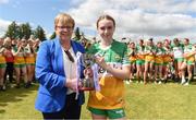 8 June 2024; Offaly captain Sophie Farrelly receives the trophy from Kathleen Kane, representing the LGFA, following the LGFA All-Ireland U14 Championship Silver Final match between Offaly and Donegal at Carrigallen GFC in Calloughs, Leitrim. Photo by Tom Beary/Sportsfile