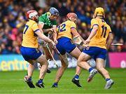 9 June 2024; David Reidy of Limerick in action against Clare players, from left, Conor Leen, Peter Duggan and Mark Rodgers during the Munster GAA Hurling Senior Championship final match between Clare and Limerick at FBD Semple Stadium in Thurles, Tipperary. Photo by Piaras Ó Mídheach/Sportsfile