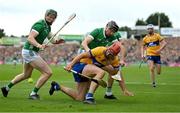 9 June 2024; Peter Duggan of Clare is tackled by Diarmaid Byrnes of Limerick during the Munster GAA Hurling Senior Championship final match between Clare and Limerick at FBD Semple Stadium in Thurles, Tipperary. Photo by Brendan Moran/Sportsfile