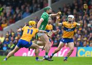 9 June 2024; Will O'Donoghue of Limerick is tackled by Mark Rodgers, 11, and Aidan McCarthy of Clare during the Munster GAA Hurling Senior Championship final match between Clare and Limerick at FBD Semple Stadium in Thurles, Tipperary. Photo by Ray McManus/Sportsfile