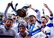 11 June 2024; Scoil Mhuire Marino captain Odhran Hession lifts the cup with team-mates after his side's victory in the Corn Herarld Division 1 Hurling Final at the Allianz Cumann na mBunscol Finals at Croke Park in Dublin. Photo by Shauna Clinton/Sportsfile