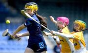 14 June 2024; Clodagh McCarthy of Dublin is tackled by Antrim players Laoise Carey, left, and Caoilbhe O'Kane during the friendship games between Dublin Cumann na mBunscol and Antrim Cumann na mBunscol at Parnell Park in Dublin. Photo by Shauna Clinton/Sportsfile