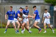 15 June 2024; Ruaidhrí Lawlor of Kildare is tackled by Ultan O'Reilly, left, and Senan Macken of Cavan during the Electric Ireland GAA Football All-Ireland Minor Championship Tier 2 final match between Cavan and Kildare at Páirc Tailteann in Navan, Meath. Photo by Tyler Miller/Sportsfile