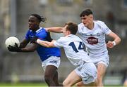 15 June 2024; Joshua Shehu of Cavan in action against Austin Donegan, 14, and Evan Boyle of Kildare during the Electric Ireland GAA Football All-Ireland Minor Championship Tier 2 final match between Cavan and Kildare at Páirc Tailteann in Navan, Meath. Photo by Tyler Miller/Sportsfile