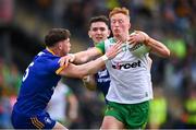 15 June 2024; Oisin Gallen of Donegal is tackled by Cillian Rouine of Clare during the GAA Football All-Ireland Senior Championship Round 3 match between Clare and Donegal at Hastings Insurance MacHale Park in Castlebar, Mayo. Photo by Ben McShane/Sportsfile