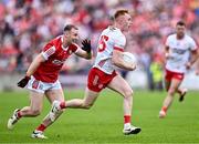 15 June 2024; Seán O’Donnell of Tyrone in action against Matty Taylor of Cork during the GAA Football All-Ireland Senior Championship Round 3 match between Cork and Tyrone at Glenisk O'Connor Park in Tullamore, Offaly. Photo by Piaras Ó Mídheach/Sportsfile