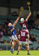 15 June 2024; Jonah Donnellan of Galway in action against Euan Murray of Tipperary during the Electric Ireland GAA Hurling All-Ireland Minor Hurling Championship semi-final match between Tipperary and Galway at TUS Gaelic Grounds in Limerick. Photo by Tom Beary/Sportsfile