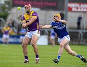 15 June 2024; Lee Chin of Wexford in action against Tom Cuddy of Laois during the GAA Hurling All-Ireland Senior Championship preliminary quarter-final match between Laois and Wexford at Laois Hire O'Moore Park in Portlaoise, Laois. Photo by Matt Browne/Sportsfile