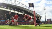 15 June 2024; Antoine Frisch of Munster on the way to scoring his side's first try despite the efforts of Sebastian Cancelliere of Glasgow Warriors during the United Rugby Championship semi-final match between Munster and Glasgow Warriors at Thomond Park in Limerick. Photo by Brendan Moran/Sportsfile