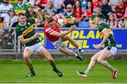 16 June 2024; Ryan Burns of Louth is tackled by Diarmuid O'Connor, left, and Tom O'Sullivan of Kerry during the GAA Football All-Ireland Senior Championship Round 3 match between Kerry and Louth at MW Hire O'Moore Park in Portlaoise, Laois. Photo by Tyler Miller/Sportsfile
