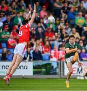 16 June 2024; Tony Brosnan of Kerry kicks a score despite the efforts of Tommy Durnin of Louth during the GAA Football All-Ireland Senior Championship Round 3 match between Kerry and Louth at MW Hire O'Moore Park in Portlaoise, Laois. Photo by Tyler Miller/Sportsfile