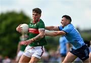 16 June 2024; Jordan Flynn of Mayo in action against Colm Basquel of Dublin during the GAA Football All-Ireland Senior Championship Round 3 match between Dublin and Mayo at Dr Hyde Park in Roscommon. Photo by Daire Brennan/Sportsfile