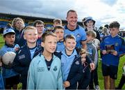 16 June 2024; Ciaran Kilkenny of Dublin poses for a picture with young supporters after the GAA Football All-Ireland Senior Championship Round 3 match between Dublin and Mayo at Dr Hyde Park in Roscommon. Photo by Ray McManus/Sportsfile