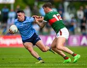 16 June 2024; Brian Howard of Dublin is tackled by Jordan Flynn of Mayo during the GAA Football All-Ireland Senior Championship Round 3 match between Dublin and Mayo at Dr Hyde Park in Roscommon. Photo by Ray McManus/Sportsfile