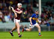 15 June 2024; Jonah Donnellan of Galway in action against Cillian Minogue of Tipperary during the Electric Ireland GAA Hurling All-Ireland Minor Hurling Championship semi-final match between Tipperary and Galway at TUS Gaelic Grounds in Limerick. Photo by Tom Beary/Sportsfile