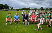 18 June 2024; In attendance at the launch of the GAA Football All-Ireland Senior Championship National 2024 at The Glen Centre in Maghera, Derry, are footballers from left, Caolan McColgan of Donegal, Brian Howard of Dublin, Emmett Bradley of Derry and Ruairi Murphy of Kerry with Uachtarán Chumann Lúthchleas Gael Jarlath Burns, the Sam Maguire Cup and young players from Watty Grahams GAC Glen. Photo by Brendan Moran/Sportsfile