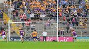 22 June 2024; Lee Chin of Wexford shoots past Clare goalkeeper Eibhear Quilligan to score a 30th minute penalty during the GAA Hurling All-Ireland Senior Championship quarter-final match between Clare and Wexford at FBD Semple Stadium in Thurles, Tipperary. Photo by Ray McManus/Sportsfile