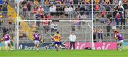22 June 2024; Lee Chin of Wexford shoots past Clare goalkeeper Eibhear Quilligan to score a 30th minute penalty during the GAA Hurling All-Ireland Senior Championship quarter-final match between Clare and Wexford at FBD Semple Stadium in Thurles, Tipperary. Photo by Ray McManus/Sportsfile