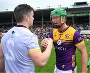 22 June 2024; Tony Kelly of Clare is congratulated by Matthew O'Hanlon of Wexford after the GAA Hurling All-Ireland Senior Championship quarter-final match between Clare and Wexford at FBD Semple Stadium in Thurles, Tipperary. Photo by Ray McManus/Sportsfile