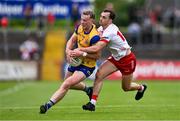22 June 2024; Eoin McCormack of Roscommon is tackled by Darragh Canavan of Tyrone during the GAA Football All-Ireland Senior Championship preliminary quarter-final match between Tyrone and Roscommon at O'Neill's Healy Park in Omagh, Tyrone. Photo by Ben McShane/Sportsfile