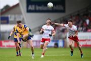 22 June 2024; Daire Cregg of Roscommon kicks a point despite the attention of Niall Devlin of Tyrone during the GAA Football All-Ireland Senior Championship preliminary quarter-final match between Tyrone and Roscommon at O'Neill's Healy Park in Omagh, Tyrone. Photo by Ben McShane/Sportsfile