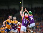 22 June 2024; John Conlon of Clare, left, and Cathal Dunbar of Wexford look on as their team mates Lee Chin, 11, and Conor McDonald contest a dropping ball with Clare full-back Conor Cleary during the GAA Hurling All-Ireland Senior Championship quarter-final match between Clare and Wexford at FBD Semple Stadium in Thurles, Tipperary. Photo by Ray McManus/Sportsfile