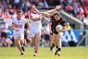23 June 2024; Bevan Duffy of Louth in action against Tommy Walsh of Cork during the GAA Football All-Ireland Senior Championship preliminary quarter-final match between Louth and Cork at Grattan Park in Inniskeen, Monaghan. Photo by Ben McShane/Sportsfile