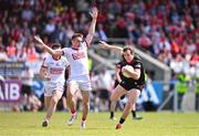 23 June 2024; Bevan Duffy of Louth in action against Tommy Walsh of Cork during the GAA Football All-Ireland Senior Championship preliminary quarter-final match between Louth and Cork at Grattan Park in Inniskeen, Monaghan. Photo by Ben McShane/Sportsfile