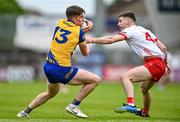 22 June 2024; Daire Cregg of Roscommon is tackled by Niall Devlin of Tyrone during the GAA Football All-Ireland Senior Championship preliminary quarter-final match between Tyrone and Roscommon at O'Neill's Healy Park in Omagh, Tyrone. Photo by Ben McShane/Sportsfile