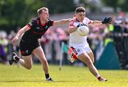 23 June 2024; Seán Powter of Cork and Paul Mathews of Louth during the GAA Football All-Ireland Senior Championship preliminary quarter-final match between Louth and Cork at Grattan Park in Inniskeen, Monaghan. Photo by Ben McShane/Sportsfile