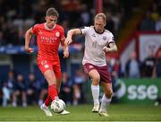 28 June 2024; Evan Caffrey of Shelbourne in action against Stephen Walsh of Galway United during the SSE Airtricity Men's Premier Division match between Shelbourne and Galway United at Tolka Park in Dublin. Photo by Stephen McCarthy/Sportsfile